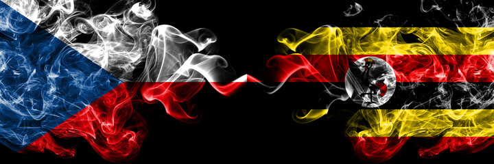 Czech Republic, Czech vs Uganda smoky mystic flags placed side by side. Thick colored silky abstract smoke flags.