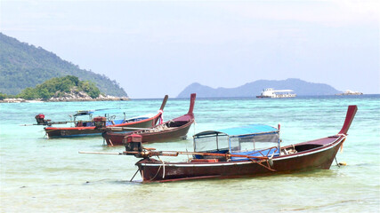 Fototapeta premium Ko Lipe, Satun, Thailand : November-9-2020 : Traditional wooden long tail boats parking at Lipe Island, Satun, Thailand.