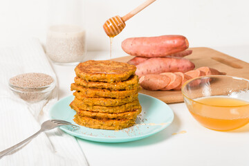 homemade autumn stack vegetarian pancakes with sweet potatoes and Chia seeds, low-calorie Breakfast, taking care of the body. watered with honey on a light background