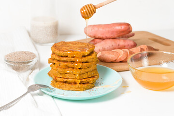 homemade autumn stack vegetarian pancakes with sweet potatoes and Chia seeds, low-calorie Breakfast, taking care of the body. watered with honey on a light background