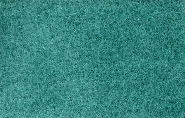 Texture of green dishwashing sponge. Abstract green background.