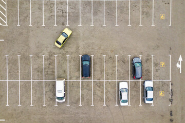 Top down aerial view of many cars on a parking lot of supermarket or on sale car dealer market. © bilanol