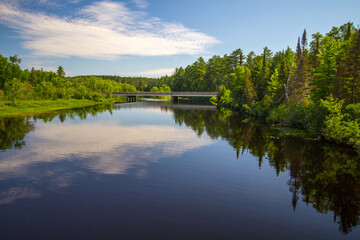 Fototapeta na wymiar The Au Sable River. The Au Sable River flows through a lush remote wilderness forest in northern Michigan.