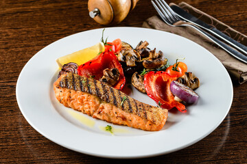 Grilled salmon steak with grilled zucchini, eggplant, bell peppers, onions, garlic. bbq salmon and grilled vegetables