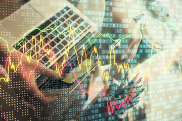 Double exposure of businesswoman hands typing on computer and financial graph hologram drawing. Stock market analysis concept.