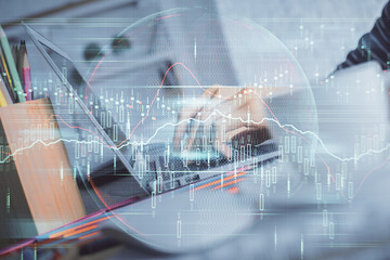 Double exposure of woman hands typing on computer and forex chart hologram drawing. Stock market invest concept.