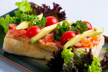 Delicious italian bruschetta with salmon and avocado.