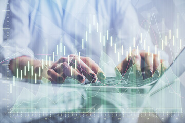 Double exposure of woman hands typing on computer and forex chart hologram drawing. Stock market invest concept.