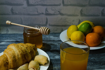 Still life with fresh fruits and glass of juice on the wooden background