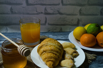 Still life with fresh fruits and glass of juice on the wooden background