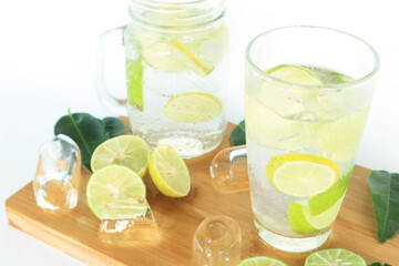 Health care, fitness, healthy nutrition diet concept. Fresh cool lemon infused water, detox drink, lemonade in a glass jug and a glass.