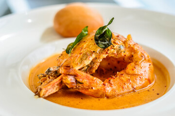 main course of King Prawn served in Bang Sauce with a bun