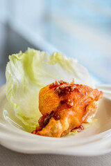 main course of Deep fried Oyster in Lettuce Cup served in a white china porcelain bowl