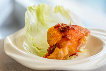 main course of Deep fried Oyster in Lettuce Cup served in a white china porcelain bowl
