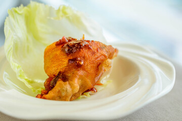 main course of Deep fried Oyster in Lettuce Cup served in a white china porcelain bowl