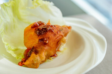 main course of Deep fried Oyster in Lettuce Cup served in a white china porcelain bowl