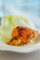 main course of Deep fried Oyster in Lettuce Cup served in a white china porcelain bowl