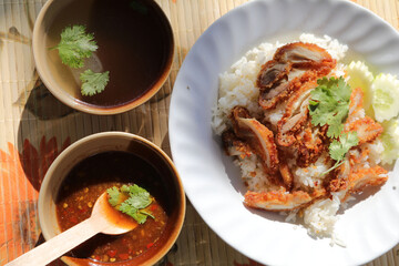 fried chicken rice set, a popular Thai dish - dipping sauce + broth - is a healthy fast food, available on the streets and at major food courts around the country, slightly spicy and delicious.