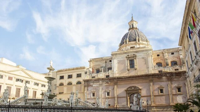 Time lapse of pretoria baroque fountain in Palermo, Sicily, Italy during a sunny cloudy day with Santa Caterina church in background