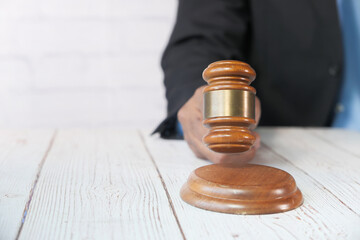 close up of person's hand striking the gavel.