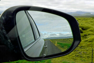 Fototapeta na wymiar Reflection of the road in rear view mirror in Iceland 