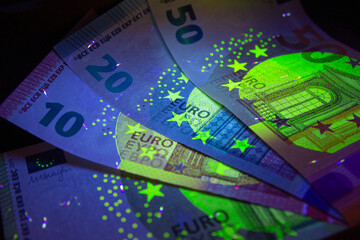 Euro currency in UV light protection.Euro in UV light.Euro currency in UV light protection.