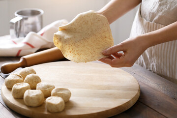 Female hands in the process of cooking homemade flatbreads - 395925714