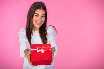 Business woman holding red gift box. Toothy smiling face. Isolated background. Beautiful happy woman holding gift box. Birthday or Valentine`s day celebrating concept