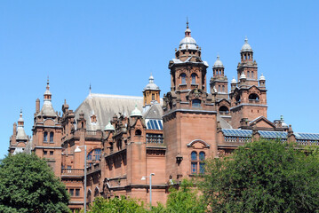Ornate Roof & Cupolas on Red Stone 19th Century Public Building against Blue Sky