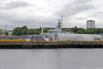 River View of Water Dockside & Industrial Buildings with Naval Vessel 