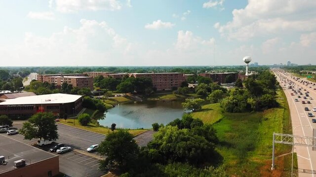 Dolly Shot of Apartment Buildings Overlooking a Pond