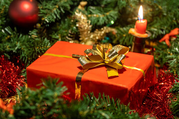 The small Christmas box with a bow, a background of the Christmas decorations.
