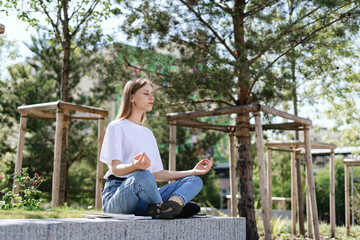 Calm adult academy student girl making meditation