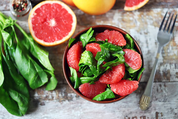 Selective focus. Spinach grapefruit salad in a bowl. Healthly food. Vegan snack.