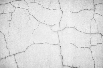 Many cracks on the surface of the old gray wall.