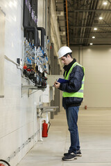 Portrait of a Caucasian man , factory engineer in work clothes controlling the work process at the helicopter manufacture.