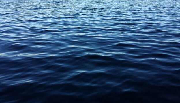 Beautiful dark blue water background with soft waves on Florida river