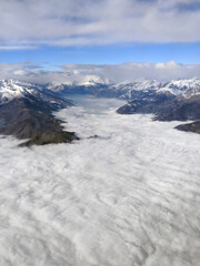 Aerial view of the Italian Alps Mountain tops emerging above the clouds