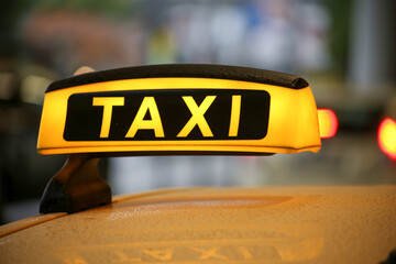 Close-up of taxi sign on yellow car