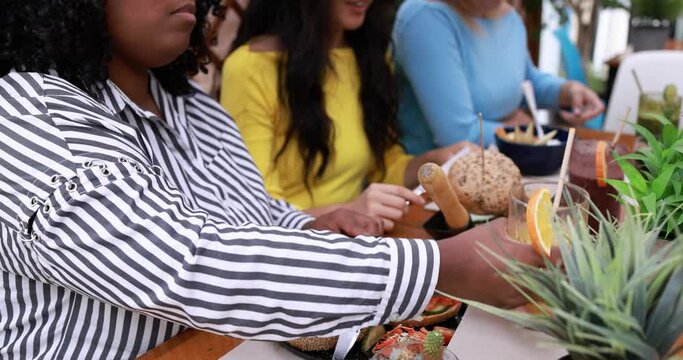 Young happy multiracial girls enjoy brunch together and eating healthy food 