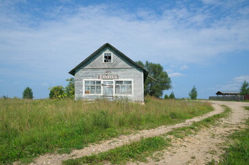 Fototapeta premium Old rural grocery store in Tver region, Russia. Sign in Russian: 