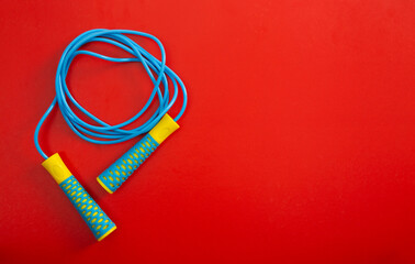 Minimalism fitness concept. Skipping rope on color background.