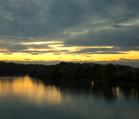 River under sunset light, clouds