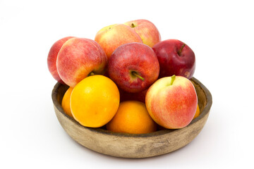 fresh fruits in a clay bowl - oranges and apples