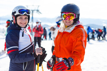 Fototapeta na wymiar Half-length portrait of two female downhill skier friends
