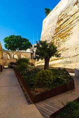 Fototapeta premium Valletta, Malta - The Railway & City Gate bridges viewed from the Laparelli Garden inside the Valletta Ditch.