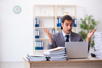 Naklejka premium Young male employee unhappy with excessive work