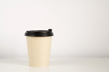 Coffee cup mockup on the white background. Empty cup on the table with copy space