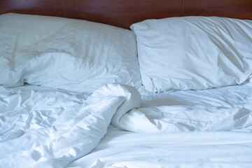 Fototapeta na wymiar The white crumpled mattress in the bedroom.
