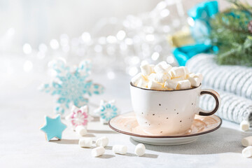 Obraz na płótnie Canvas Hot winter drink. Cup of hot chocolate with marshmallows and gingerbread cookies on white background.